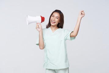 Asian patient woman wearing patient gown shouting loud holding a megaphone speaking for compensation coverage or tell insurance agent or hospital for emergency.