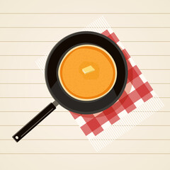 Frying pan with pancakes on white wooden table with red fringed checkered napkin