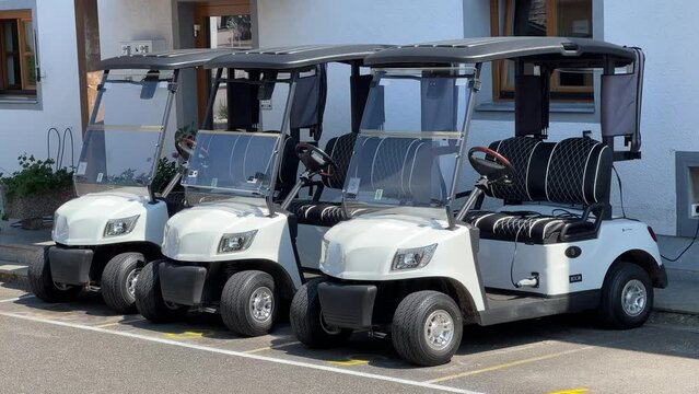 golf carts on parking lot in line