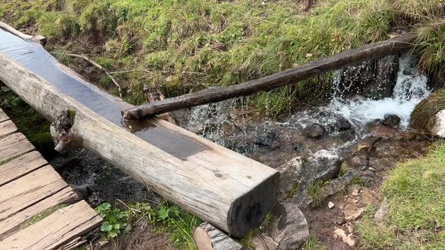 wooden standpipe on alpine hiking path