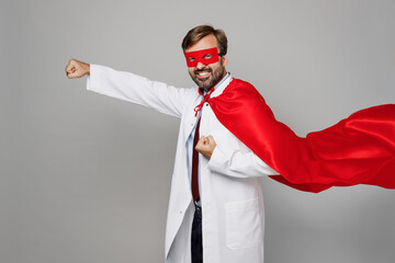 Side view male doctor man wear white medical gown suit work in hospital wear red super hero coat...