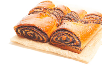 poppy seed strudel on a brown baking paper isolated on white