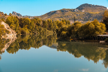 Riverside and forest on a clear day at sunrise in autumn