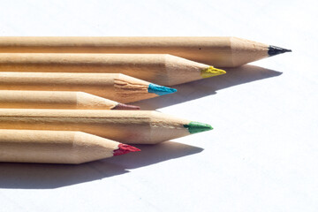 group of colored wooden pencils for freehand drawing on white background