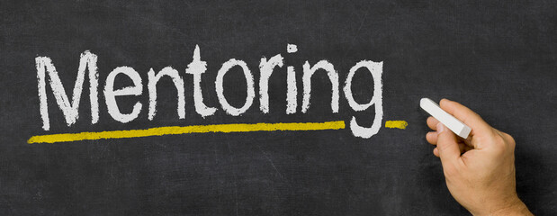 Text written on a blackboard - Mentoring