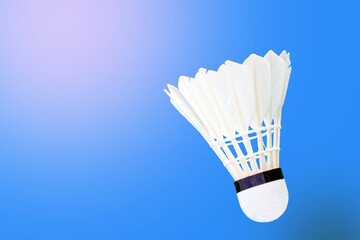 white shuttlecock on blue background. soft and selective focus.    