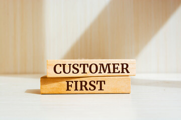 Wooden blocks with words 'Customer First'.