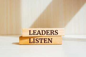 Wooden blocks with words 'Leaders Listen'.