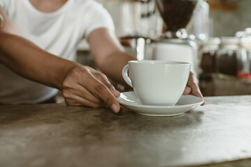 Barista serving a coffee to customer at the coffee shop.