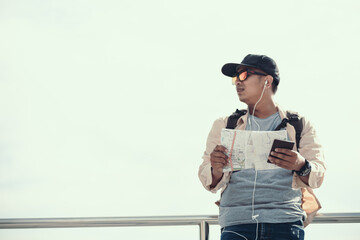 Tourists hold maps to find attractions, restaurants or hotels. backpacker and travel concept.