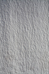 Background of natural white wall Pamukkale calcium travertine in Turkey, asymmetric pattern close-up. White cotton castle texture. Calcium stone textured