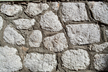 Old stone wall texture background. Rough stone wall. Big rough stones fence