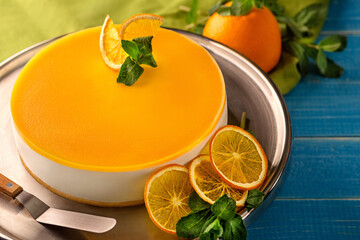 Cheesecake on shortcrust pastry with vanilla souffle and passion fruit puree garnished with candied orange slices