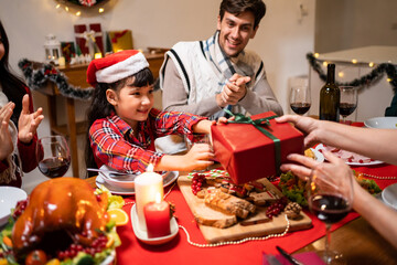 Multi-ethnic family exchanging presents during Christmas party at home