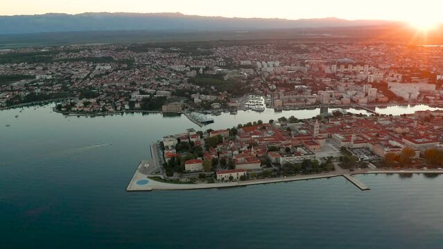 Zadar, Croatia - 4K Flying around at the old town of Zadar with Church of St. Donatus and the bell tower of the Cathedral of St. Anastasia on a summer morning with golden sunrise