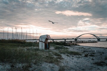 Fehmarn Sound Bridge in Germany against cloudy sky at sunset