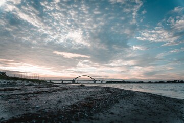 Fehmarn Sound Bridge in Germany against cloudy sky at sunset