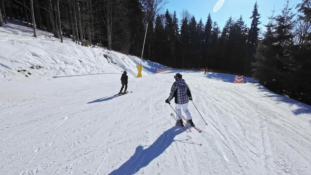 Woman goes downhill on skis