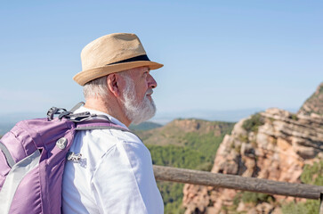 The active senior enjoys freedom and nature traveling backpacking style