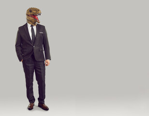 Portrait of confident cool businessman with dinosaur head isolated on light gray background. Man in...