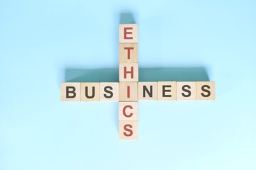 Business ethics concept. Crossword puzzle flat lay typography in blue background
