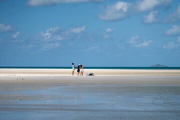 tourists and boats, on the beach at the great barrier reef in the Whitsundays in queensland Australia  