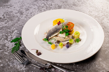 Dish of white fish with vegetables and herbs. Healthy food