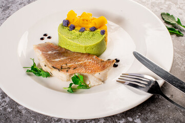 Dish of white fish with vegetables and herbs. Healthy food