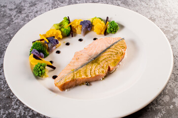 Steak of tasty salmon with vegetables and herbs. Vegetarian food. Healthy menu