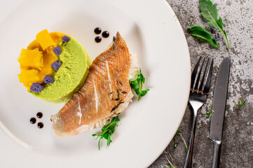 Dish of white fish with vegetables and herbs. Healthy food