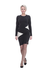 young woman in an elegant dress striding forward. isolated on a white background.