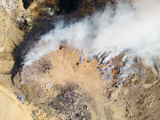 Aerial view of landfill with burning trash piles