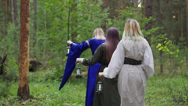 young girls in medieval long dresses walking