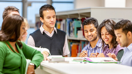 Adult Education: Group Study. A group of mature students working together with their teacher in class. From a series of related images on the subject.