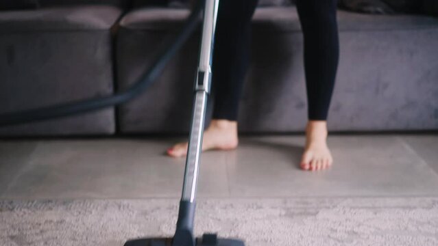 Caucasian woman has a heart attack vacuuming floor in her apartment. Adult female vacuum-cleaning the rug feels pain in her chest. Housewife cleans up the mess in the room experiences pain in heart