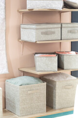Organizing home storage. Organization of home space. Storage of things in the dressing room on the shelves in textile baskets and boxes