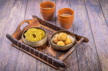 Traditional Indian snack chakli and chana laddu is a welcome snack at the festival, served with tea