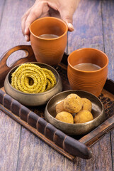 Traditional Indian snack chakli and chana laddu is a welcome snack at the festival, served with tea