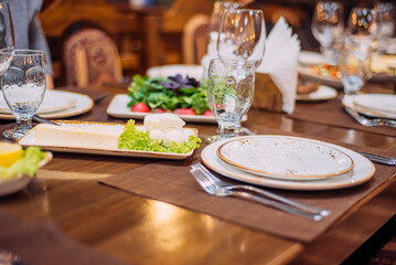 Laid table in the restaurant. Beautiful serving. Reserved table in the restaurant.