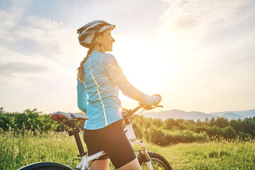 Cyclist Woman riding bike in helmets go in sports outdoors on sunny day a mountain in the forest....