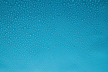 Tiny water droplets on light cold aqua blue or underwater color background as dew or spray...