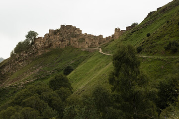 Ancient ruin of stone impregnable, destruction city on peak of mountain in highlands in Dagestan...