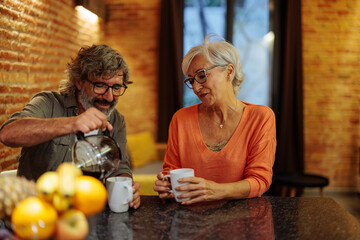 Senior couple drinking tea at home.