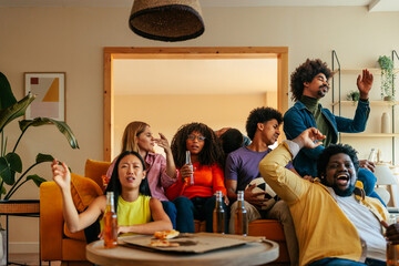 Friends watching soccer game on television.