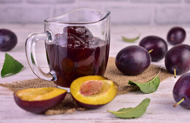 Plum jam in a glass gravy boat. Tkemali sauce.White background.
