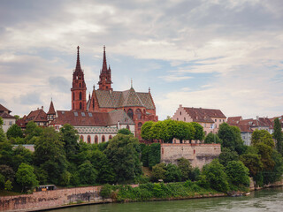 Fototapeta premium Buildings in the city centre of Basel , Switzerland. Basel Cathedral is Gothic Protestant cathedral with two spiers and tiled roof, dating back to temple of 9th century.