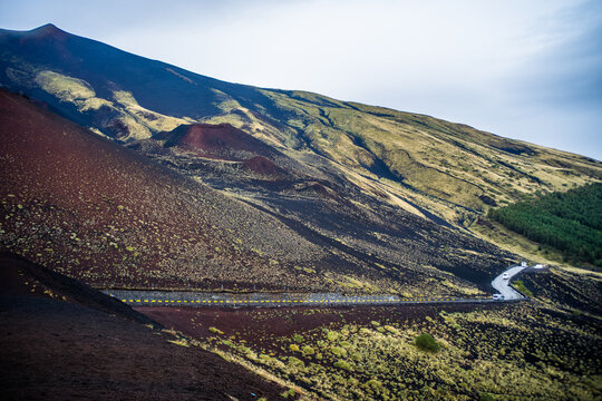 volcanic hills covered with vegetation at the foot of Mount Etna on a foggy rainy day