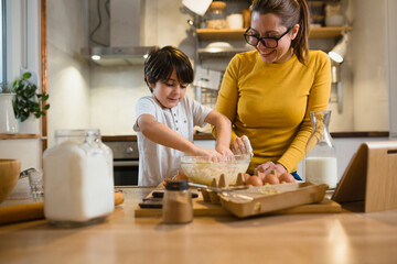 mother and son prepares food in kitchen