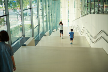 Children going down the stairs in a big building