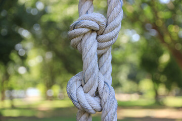 Tie a large rope in an orderly way to hold things firmly.